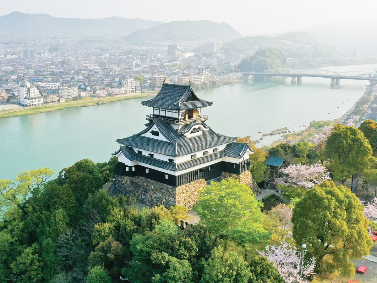 Inuyama Castle in aichi, Japan - Japan's oldest surviving castle keep, designated a National Treasure. Perched atop a hill overlooking the Kiso River, this compact fortress offers stunning views and an authentic glimpse into feudal-era castle architecture.