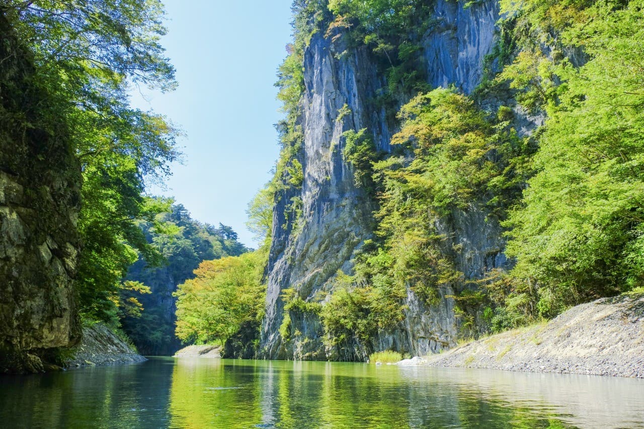 Geibikei Gorge in iwate, Japan - A spectacular limestone gorge carved over 100 million years, best explored by traditional flat-bottomed boat rides through dramatic 100-meter high cliffs along the crystal-clear Satetsu River.