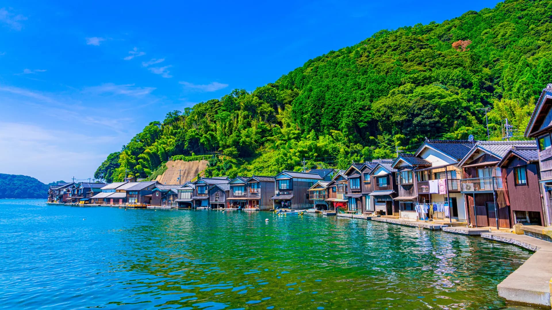 Ine Funaya Boat Houses in kyoto, Japan - A picturesque fishing village where traditional funaya boat houses line the bay, with boats stored on the ground floor and living quarters above, creating a unique waterfront townscape.