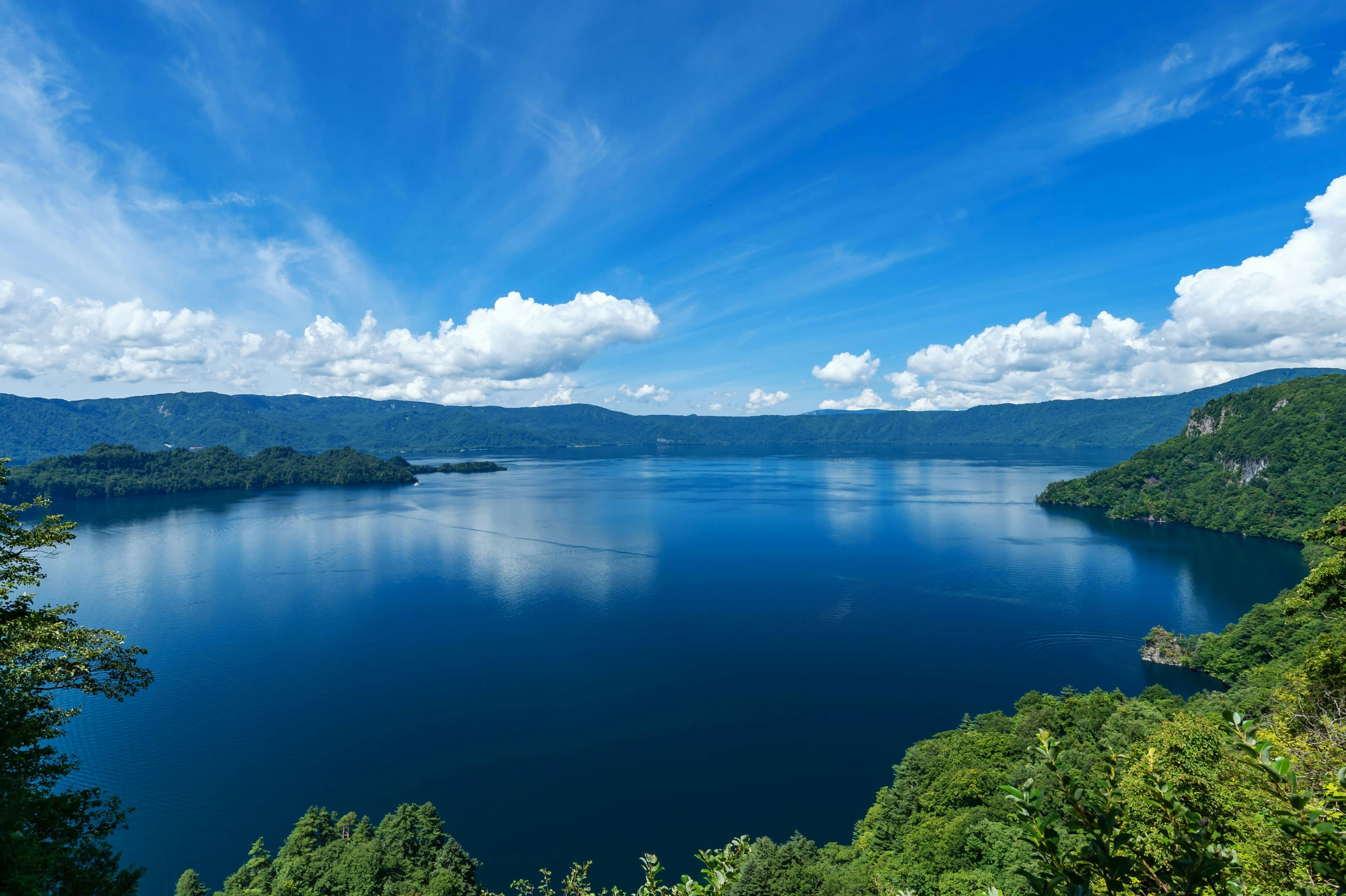 Lake Towada in aomori, Japan - A stunning caldera lake straddling Aomori and Akita prefectures, famous for crystal-clear blue waters, scenic boat cruises, and autumn foliage surrounding volcanic peaks.