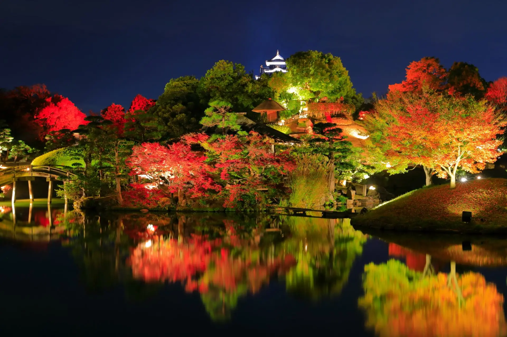 Okayama Korakuen Garden in okayama, Japan - One of Japan's Three Great Gardens featuring expansive lawns, ponds, tea houses, and views of Okayama Castle across the river.