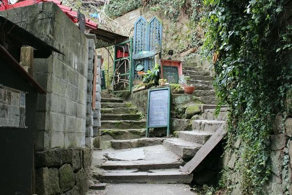 Onomichi Cat Alley in hiroshima, Japan - A charming narrow lane in Onomichi's hillside temple district adorned with cat artwork and frequented by friendly felines, offering a unique artistic walking experience.