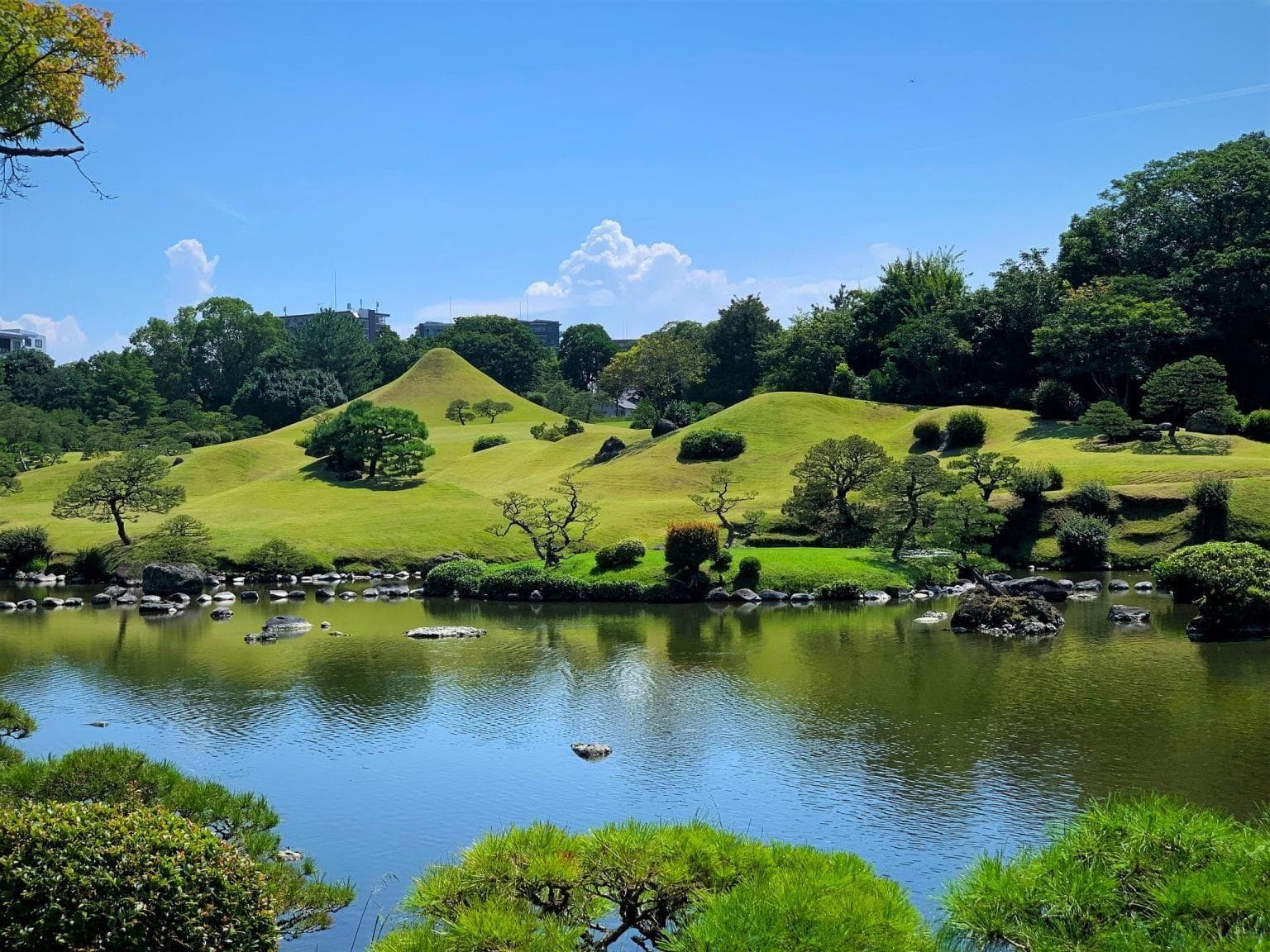 Suizenji Jojuen Garden in kumamoto, Japan - A meticulously designed Edo-period landscape garden featuring miniature representations of the 53 stations of the Tokaido highway, centered around a spring-fed pond with crystal-clear water from Mt. Aso