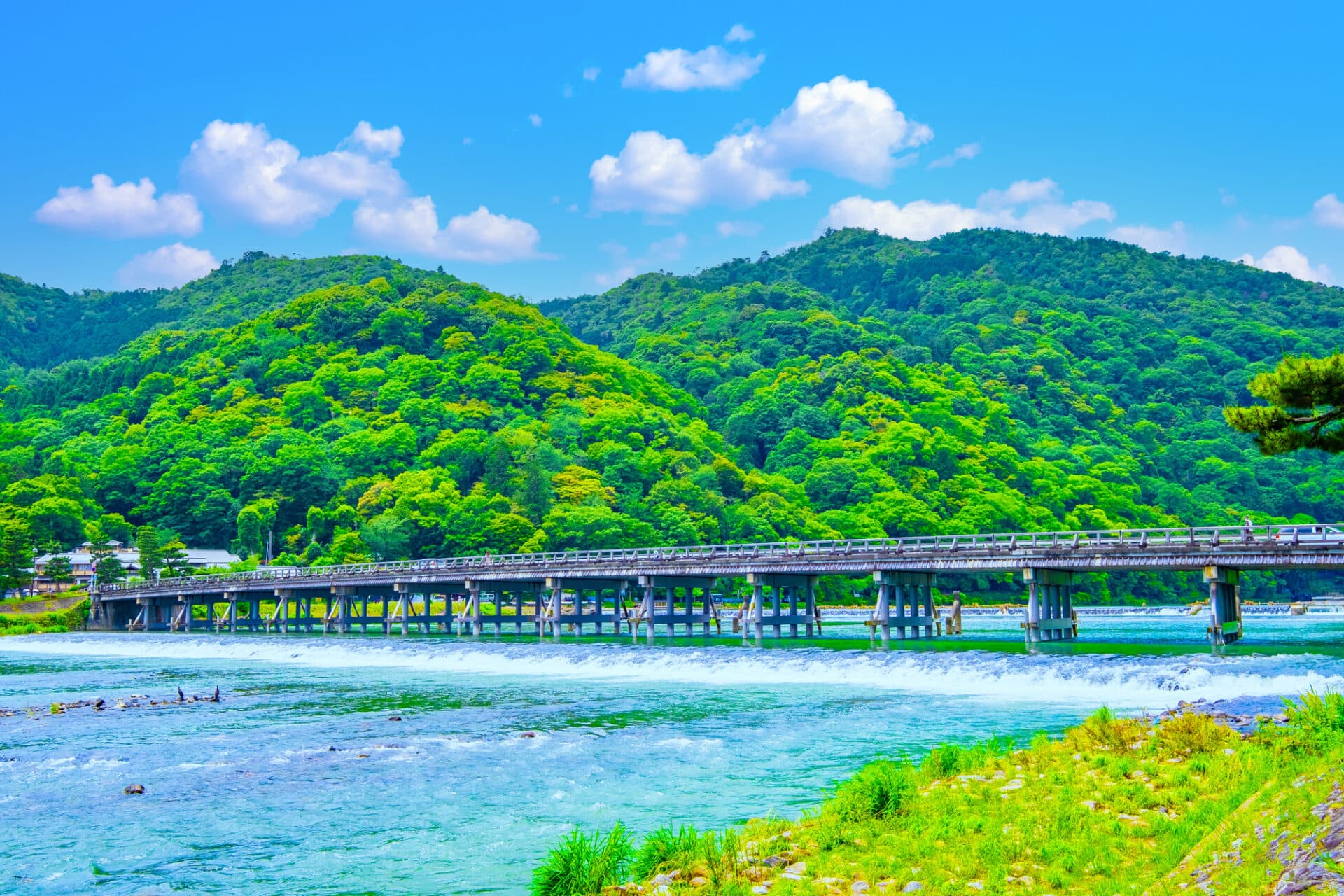 Togetsukyo Bridge Arashiyama in kyoto, Japan - Arashiyama's iconic wooden bridge spanning the Katsura River, offering picturesque mountain views and serving as the gateway to Kyoto's western scenic district famous for bamboo groves and temples.