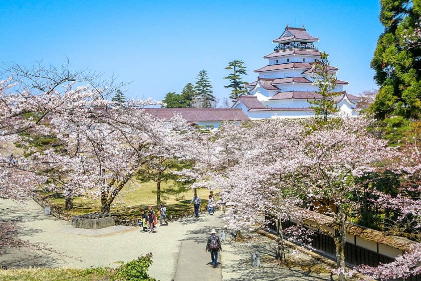 Tsuruga Castle in fukushima, Japan - A reconstructed castle in Aizu-Wakamatsu famous for its distinctive red roof tiles and heroic last stand during the Boshin War, symbolizing samurai loyalty and the end of the feudal era.