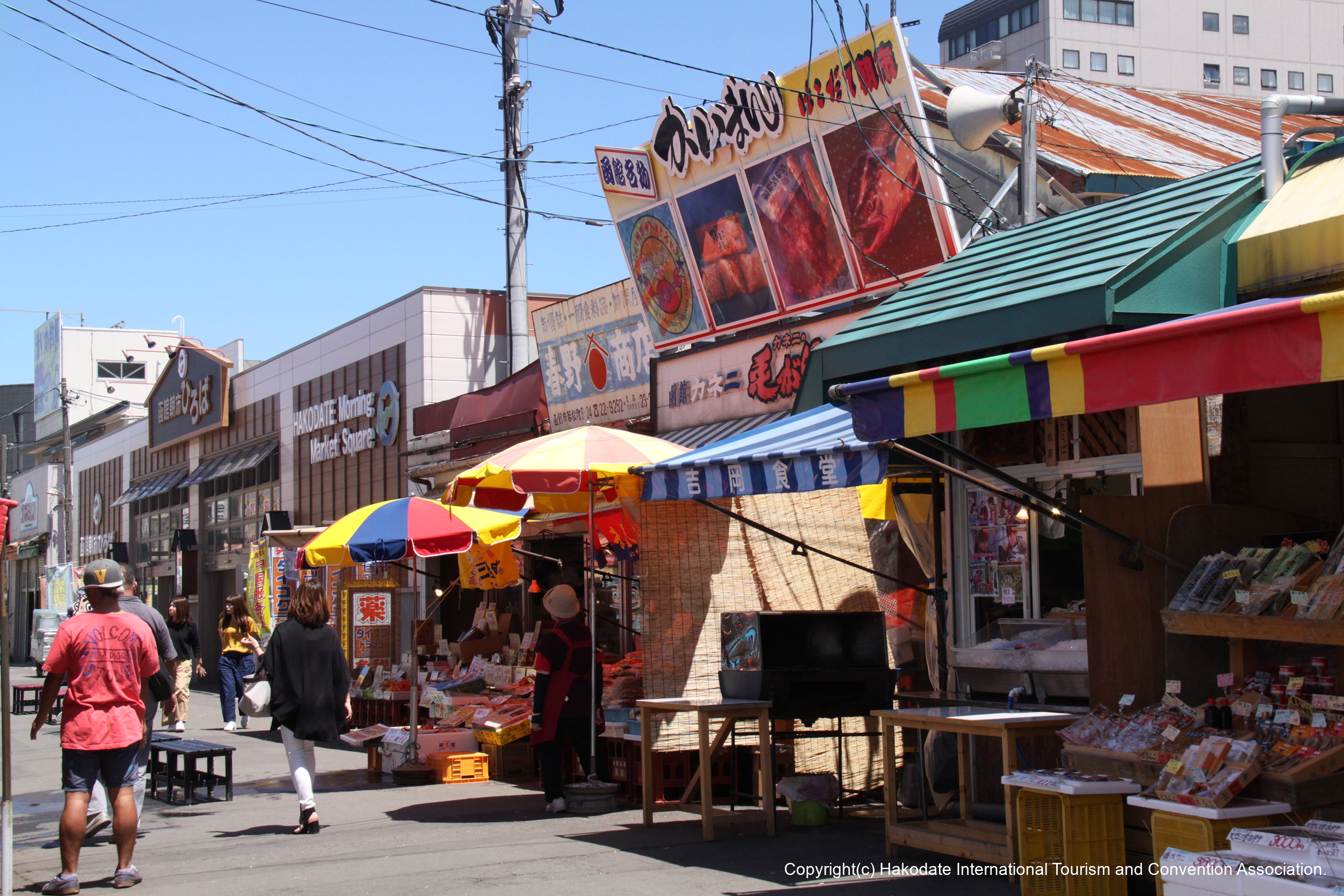 Hakodate Morning Market in hokkaido, Japan - A bustling seafood market near Hakodate Station featuring ultra-fresh local catch, seafood rice bowls, crab specialties, and the unique squid-fishing pool experience since 1945.