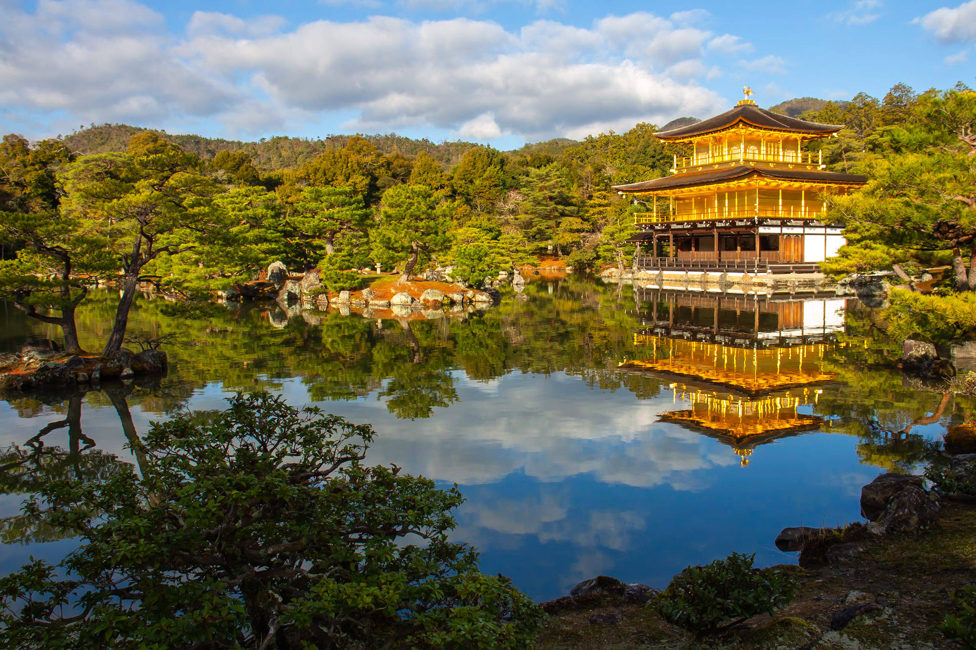 Kinkaku-ji (Golden Pavilion) in kyoto, Japan - A Zen Buddhist temple featuring a stunning three-story pavilion covered in gold leaf, set in a classical Japanese garden