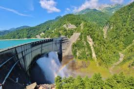 Kurobe Dam in toyama, Japan - Japan's tallest dam at 186 meters, a monumental feat of engineering built through the Northern Japan Alps. The dam's powerful water discharge and surrounding mountain scenery create one of Japan's most dramatic landscapes.
