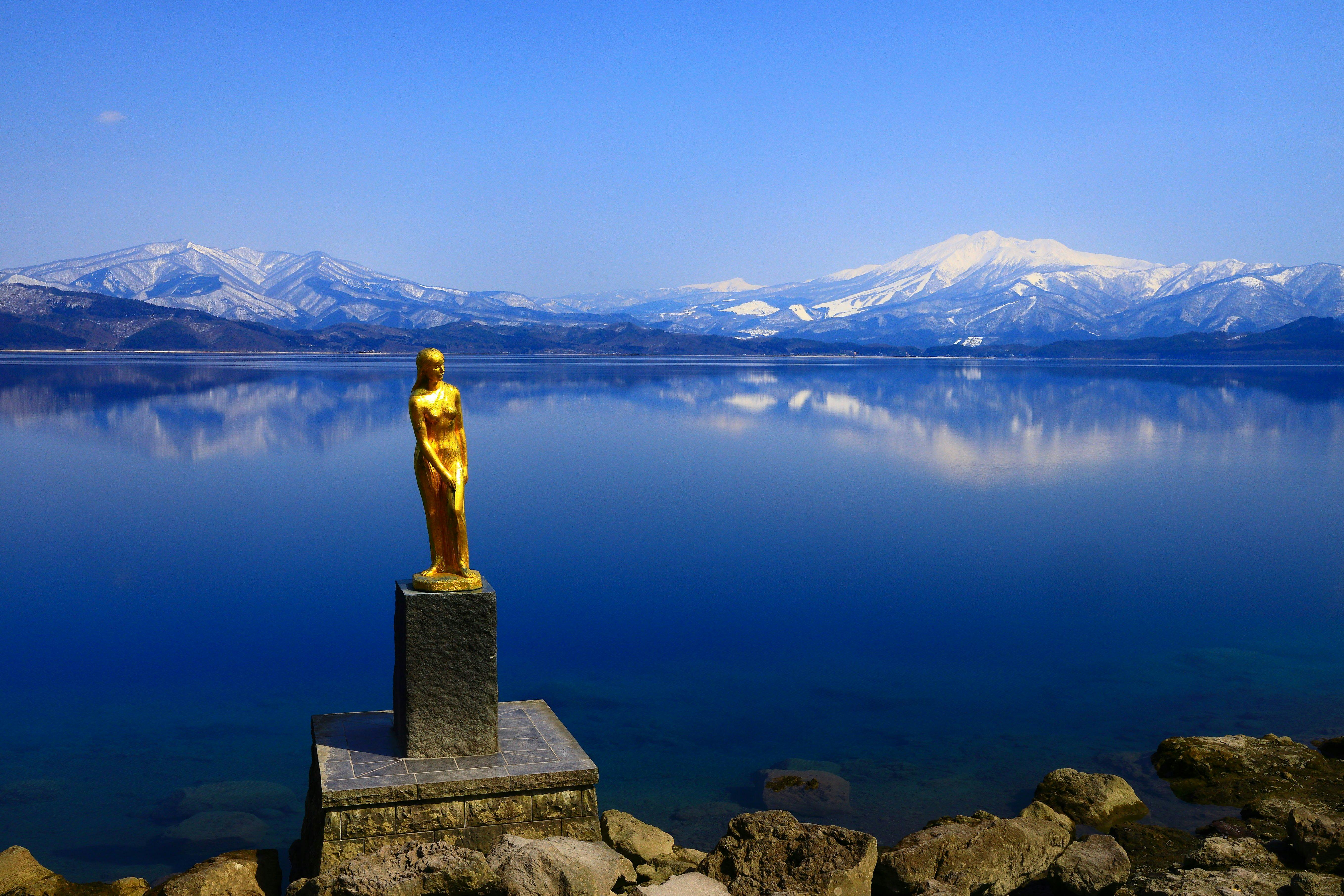 Lake Tazawa in akita, Japan - Japan's deepest lake at 423 meters, known for its stunning cobalt blue waters, legendary golden statue of Princess Tatsuko, and year-round ice-free surface.