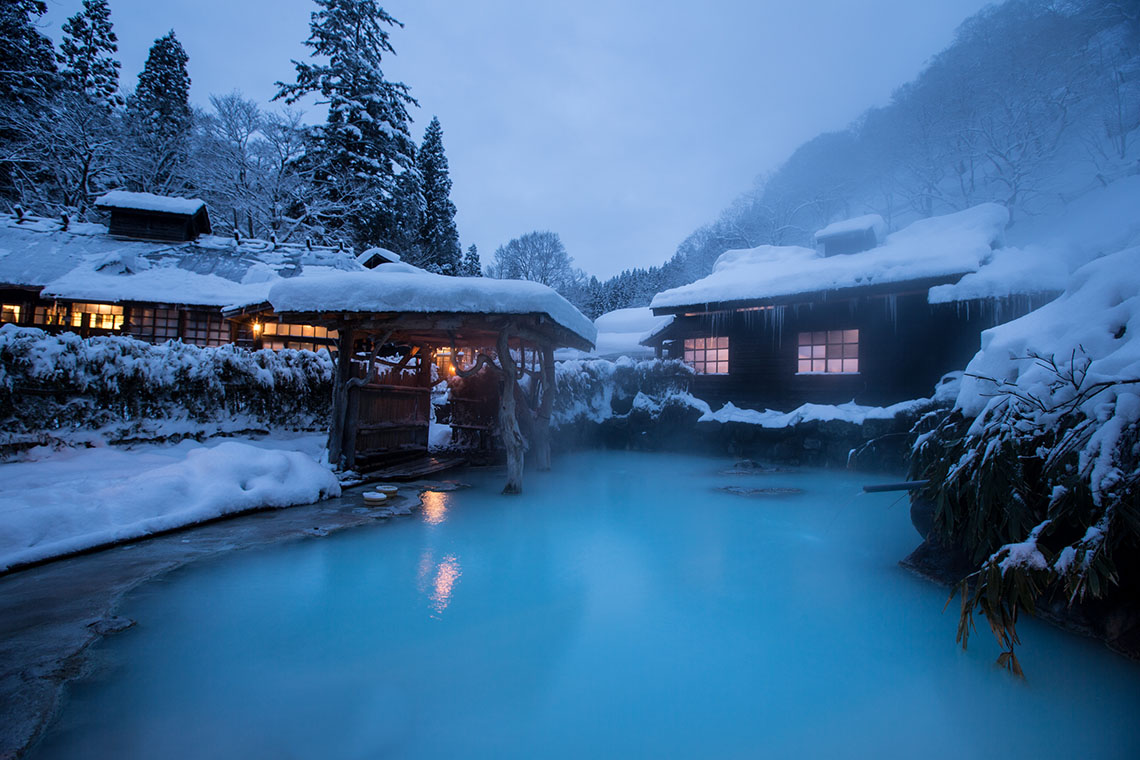 Nyuto Onsen in akita, Japan - A secluded hot spring village nestled in the mountains of Akita, featuring seven traditional ryokan with milky-white sulfur waters and pristine beech forest surroundings.