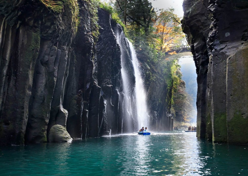 Takachiho Gorge in miyazaki, Japan - A stunning V-shaped gorge formed by ancient volcanic activity, featuring dramatic basalt cliffs up to 100 meters high and the beautiful Manai Falls. A sacred site steeped in Japanese mythology.